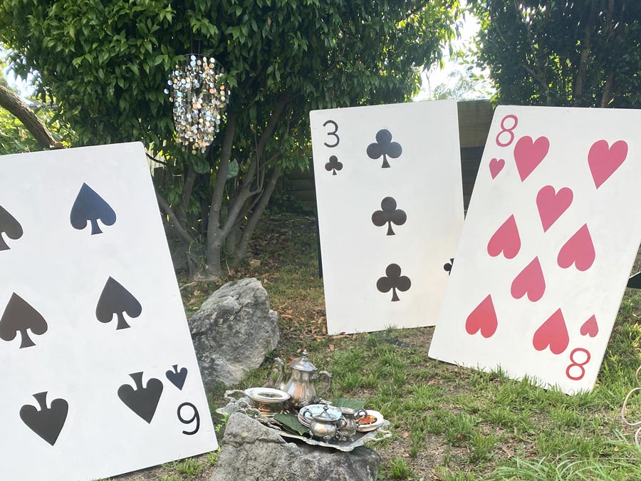 The Lair front yard with large playing card props